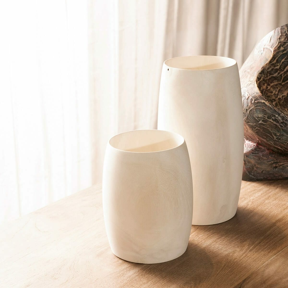 Small and medium vases up against window Small and medium vases up against window