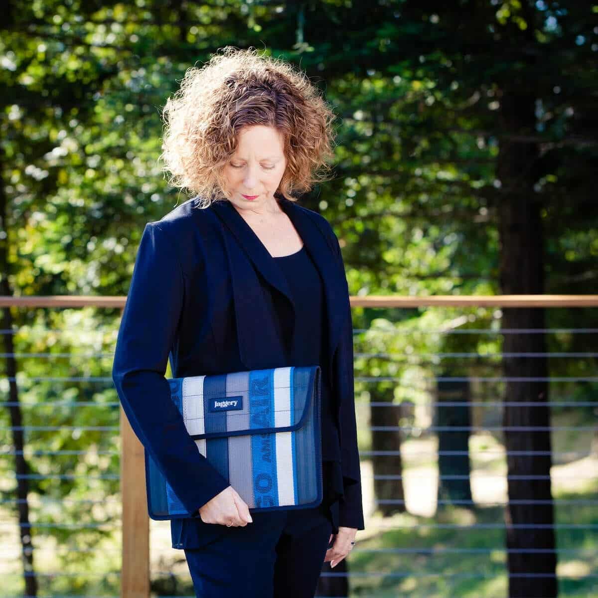woman holding laptop sleeve woman holding laptop sleeve