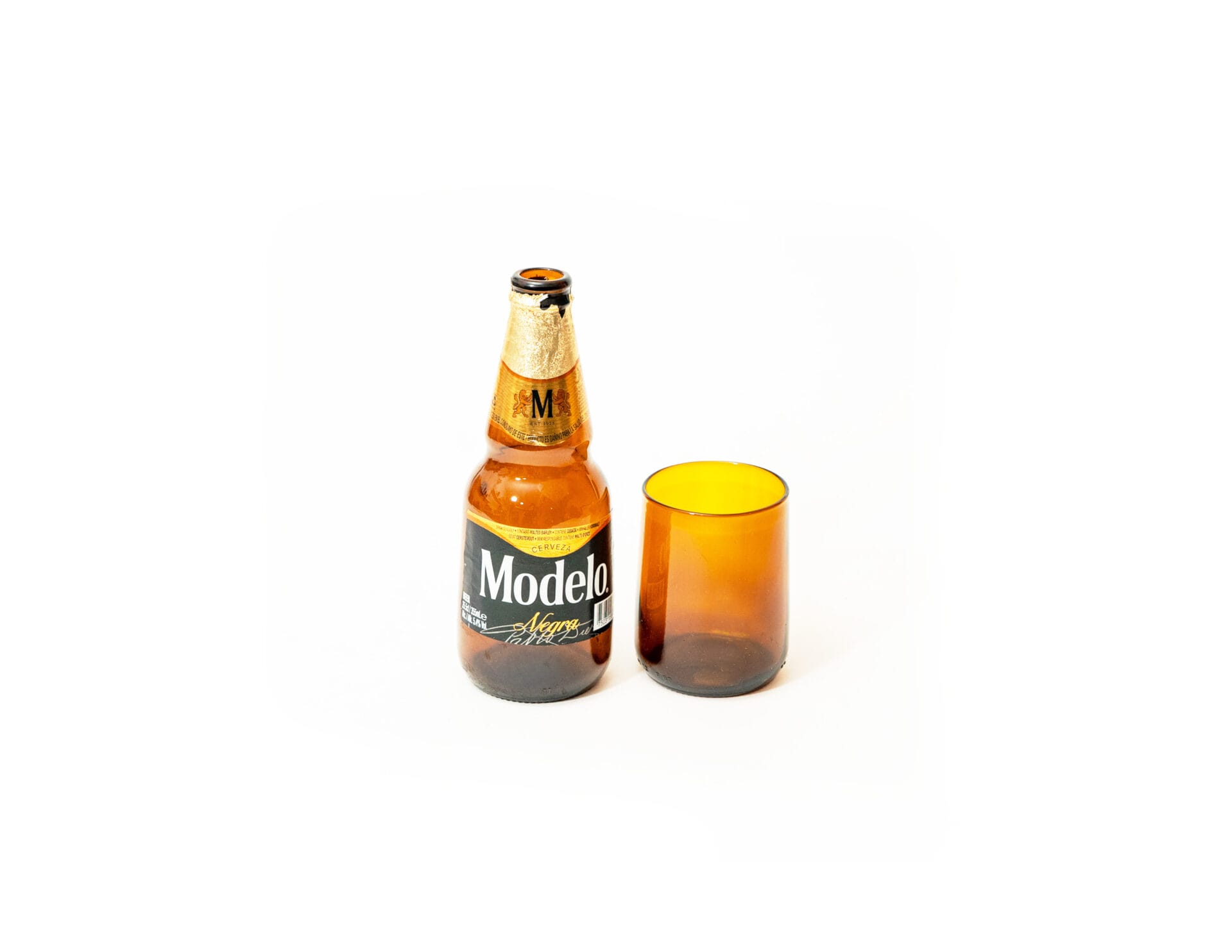 amber gronn glass and modelo beer bottle upcycled amber glass photographed next to a Modelo beer bottle like the one it was made from