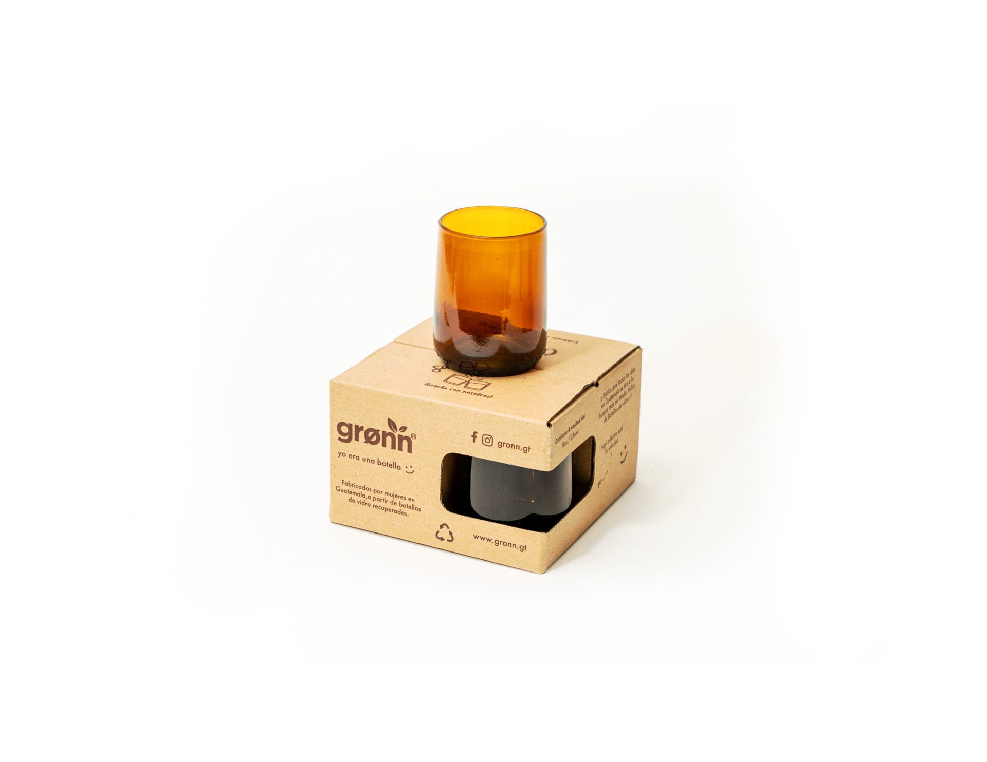 amber gronn glass on top of packaging upcycled amber glass made from an upcycled Modelo beer bottle photographed sitting on top of its packaging