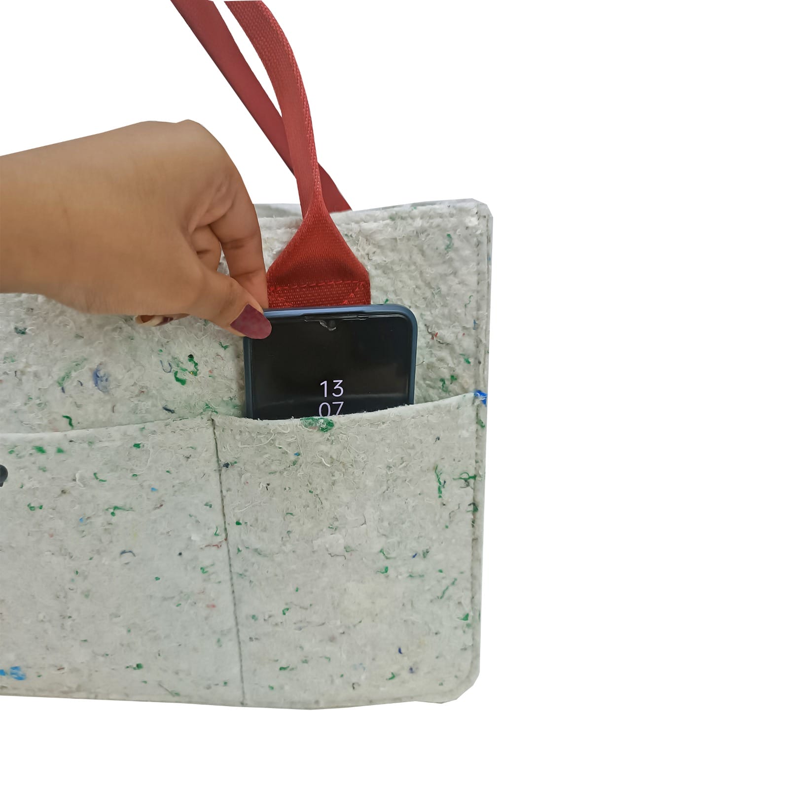 feelgood essentials cell phone pocket a hand slides a cell phone into an outer pocket of a tote bag