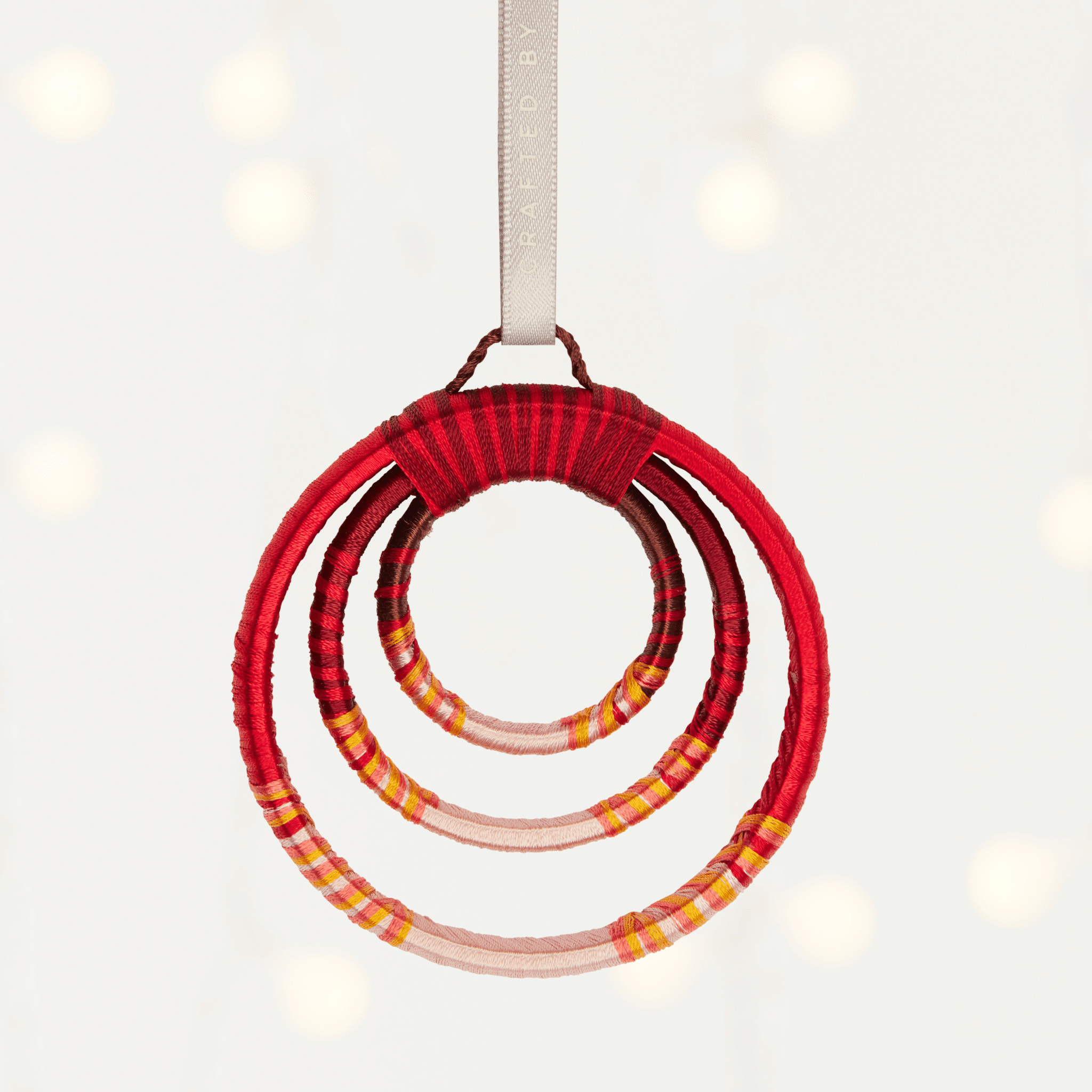 MADE51 beaming rings white background A beautiful handmade ornament made from 3 red rings, escalating in size. A great holiday gift for employees