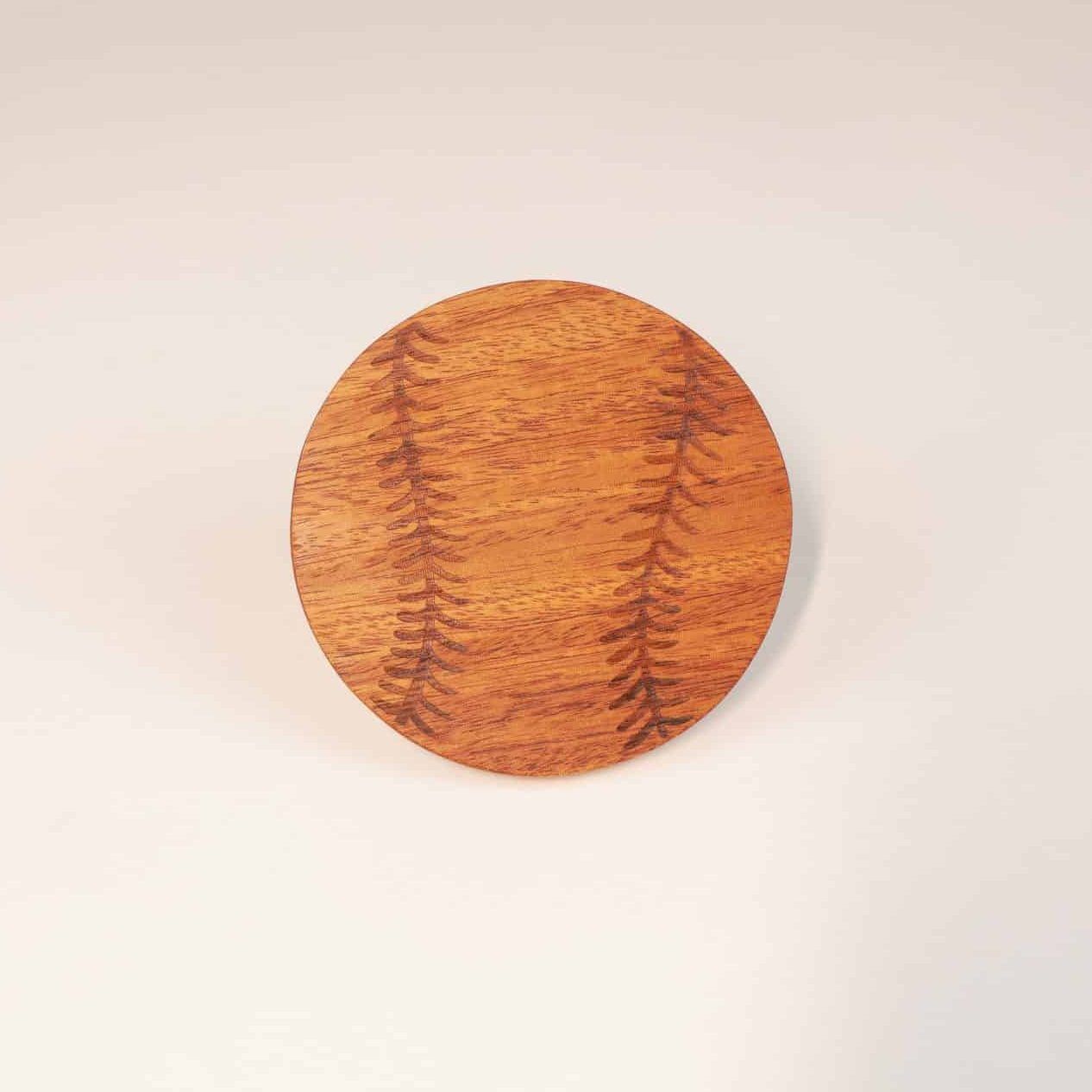 itza wood baseball coaster a single coaster engraved to look like a baseball is propped up against a white background