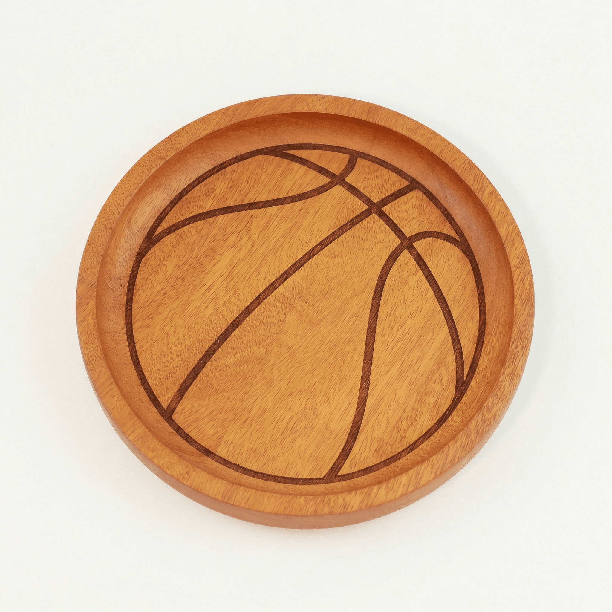 Itza Wood basketball tray plain a wooden tray with an engraving to make it look like a basketball.