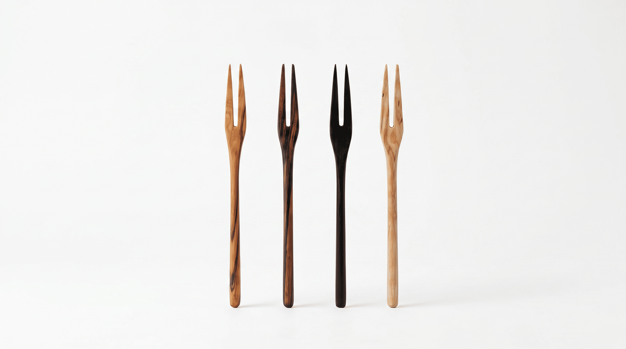 Itza Wood Picks Four handcrafted wooden picks in a variety of wood types stand against a white background