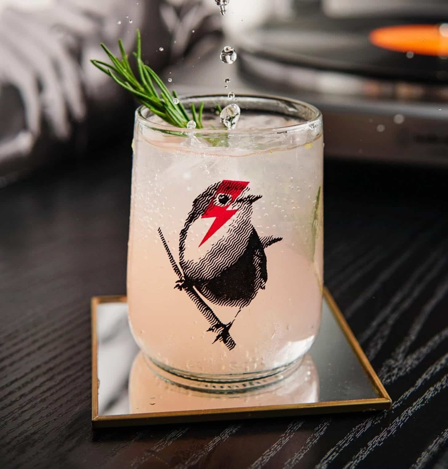 Upcycled glass with birds artwork from artist Mayte Oliva Upcycled glass with bird artwork from artist Mayte Oliva on glass coaster