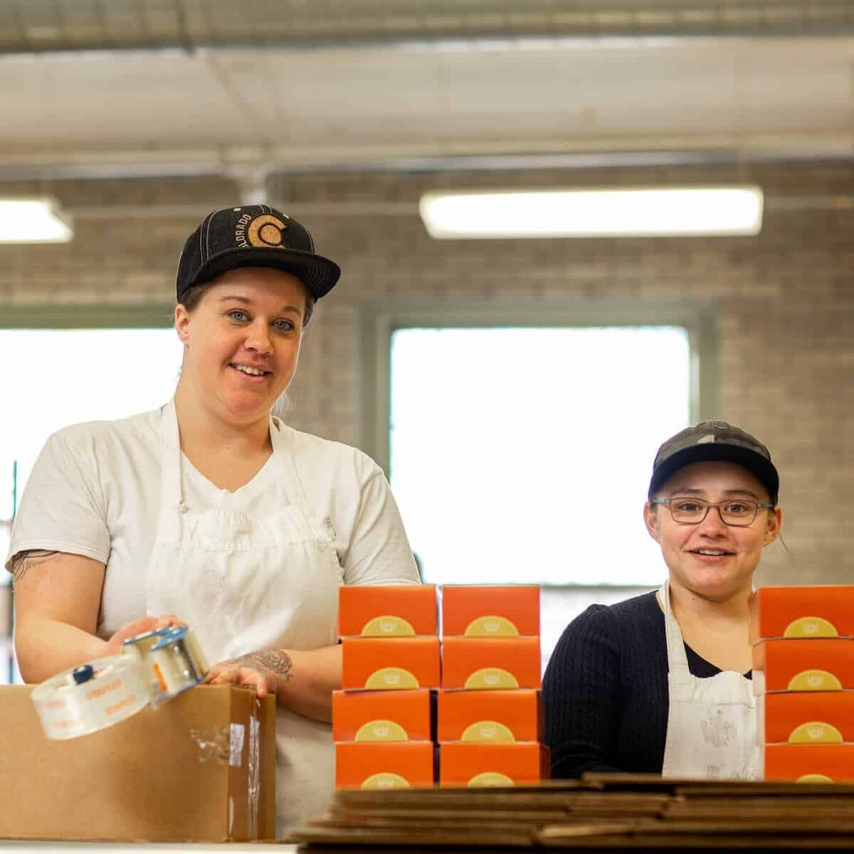 womens bean project two women packing in warehouse womens bean project two women packing in warehouse
