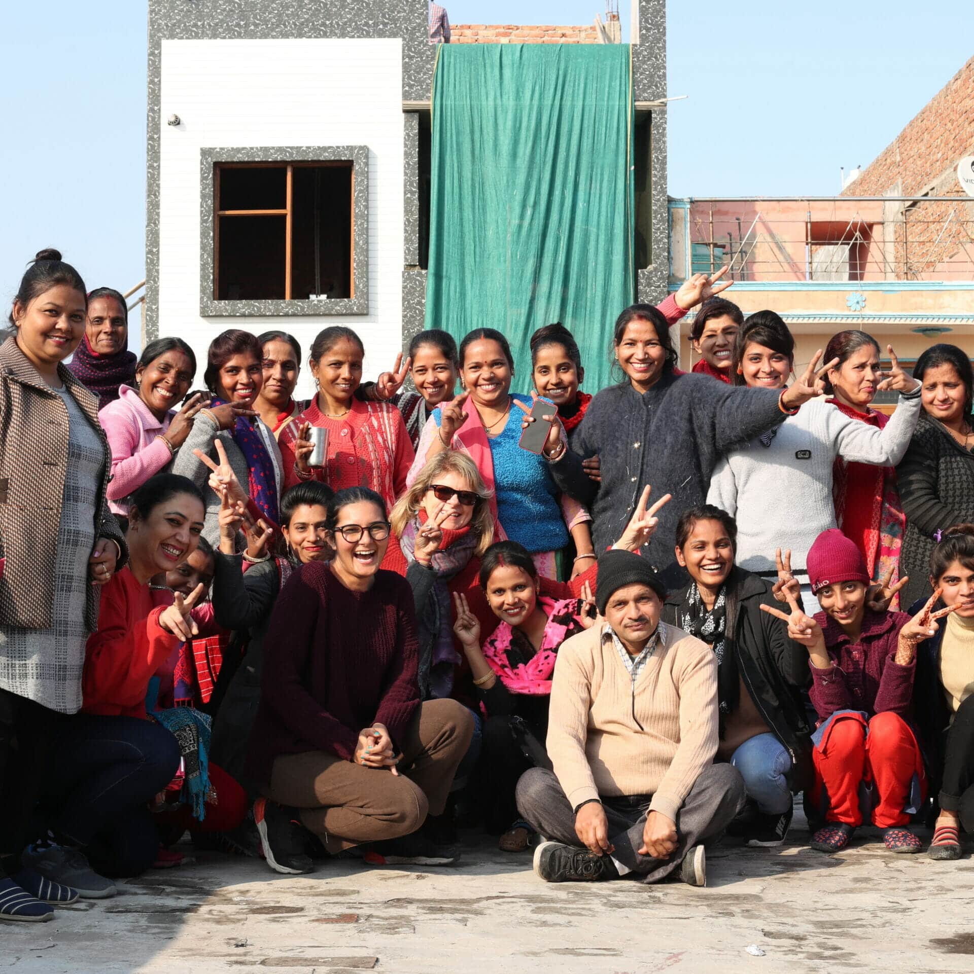 Our screen printed aprons are created by the workers at Work+Shelter, pictured here in a large group. Reusable Bamboo Cutlery Set - Image 6