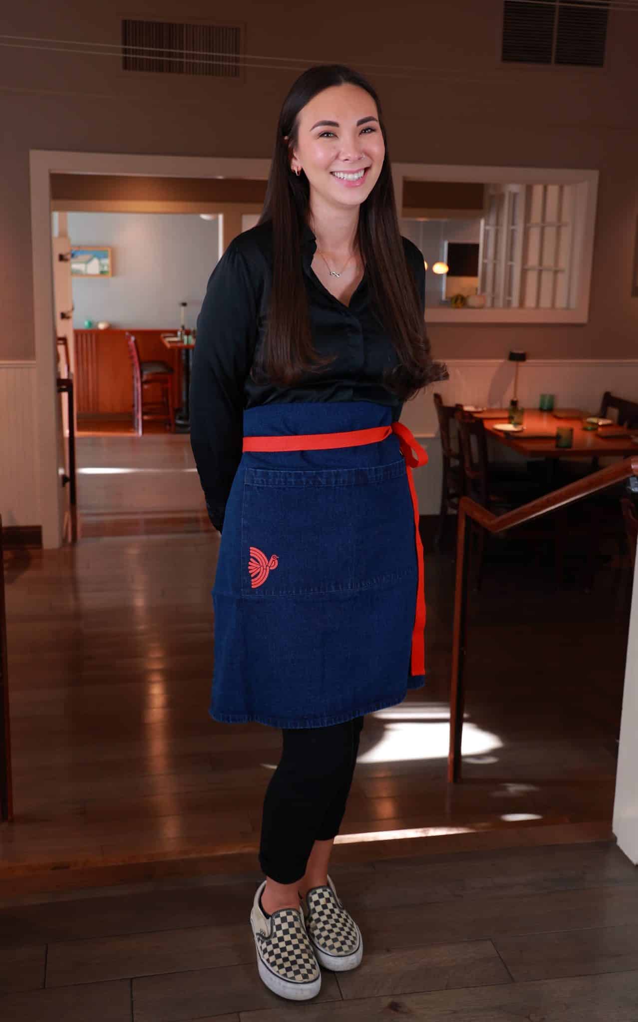 Flea Street Aprons young woman wearing corporate gift aprons in action