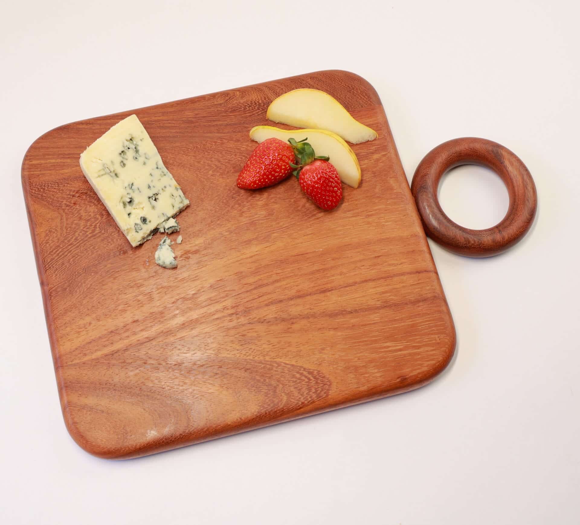 Selva Board 1 Handcrafted wooden cutting board with cheese and strawberries