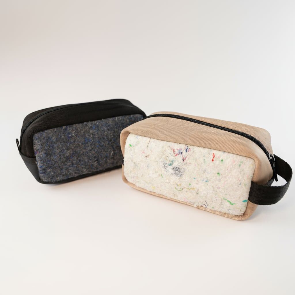 723ee309 bfc2 4cf3 8384 efc37f9ebb98 Two pouches made from recycled materials - one black and one cream colored. Great gifts for interns or onboarding gifts.