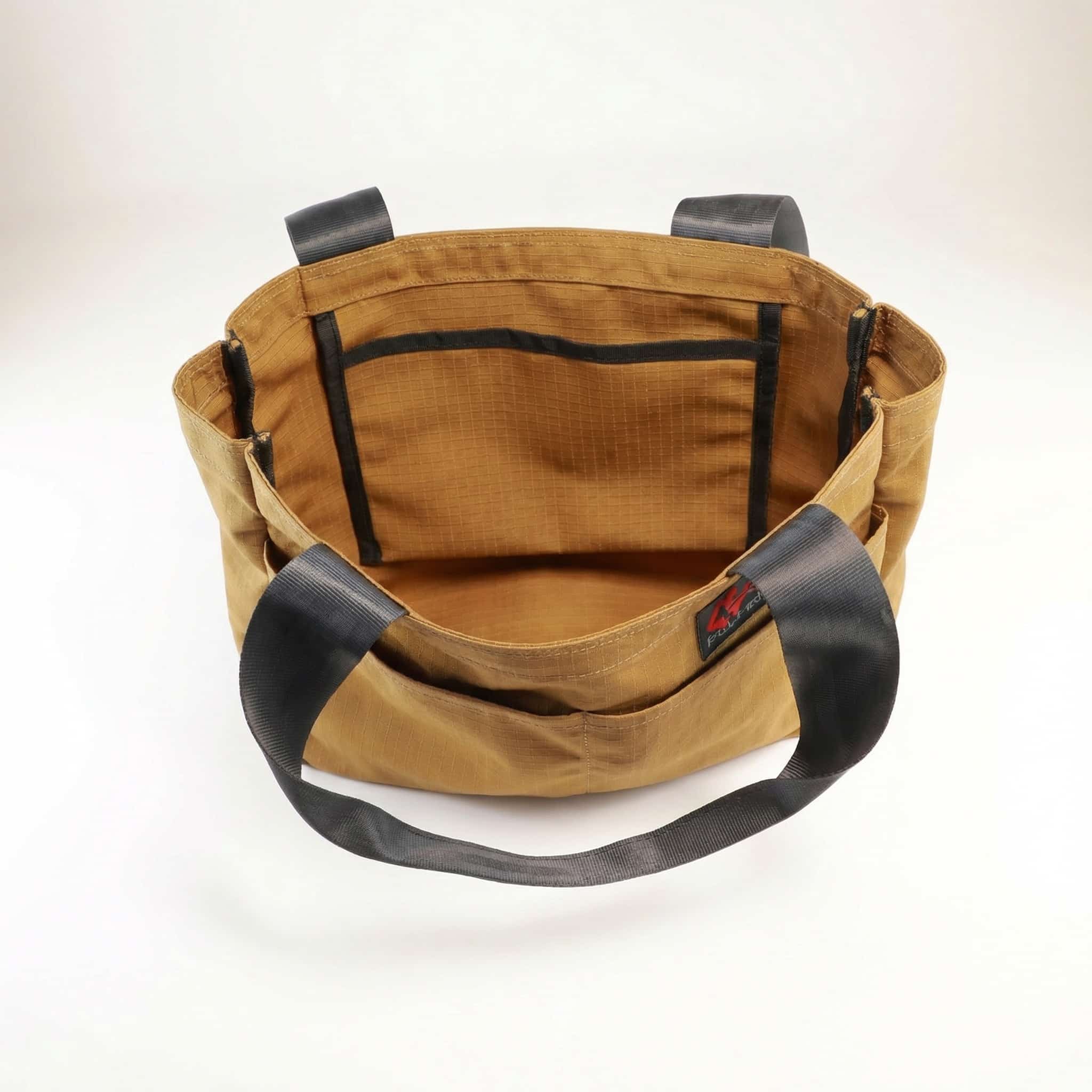 Sidekick Tote Interior Interior view of a gold brandable tote bag with black straps made from upcycled seat belts