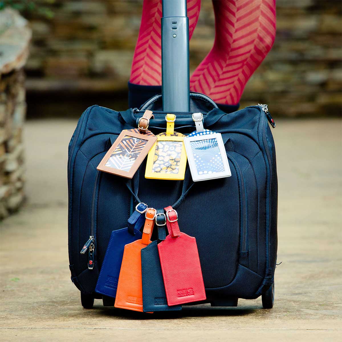 Luggage tags hanging on suitcase Luggage tags hanging on suitcase