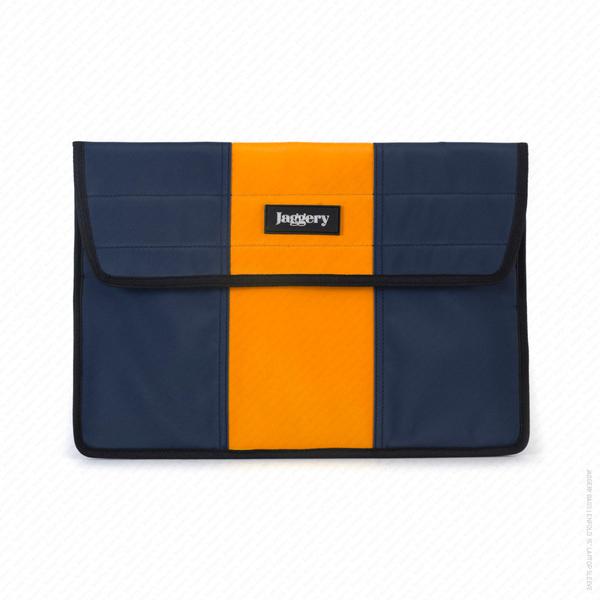 Bouncy Castle Laptop Sleeve Front View A unique gift for employees - An orange and black striped laptop sleeve made from upcycled bouncy castles