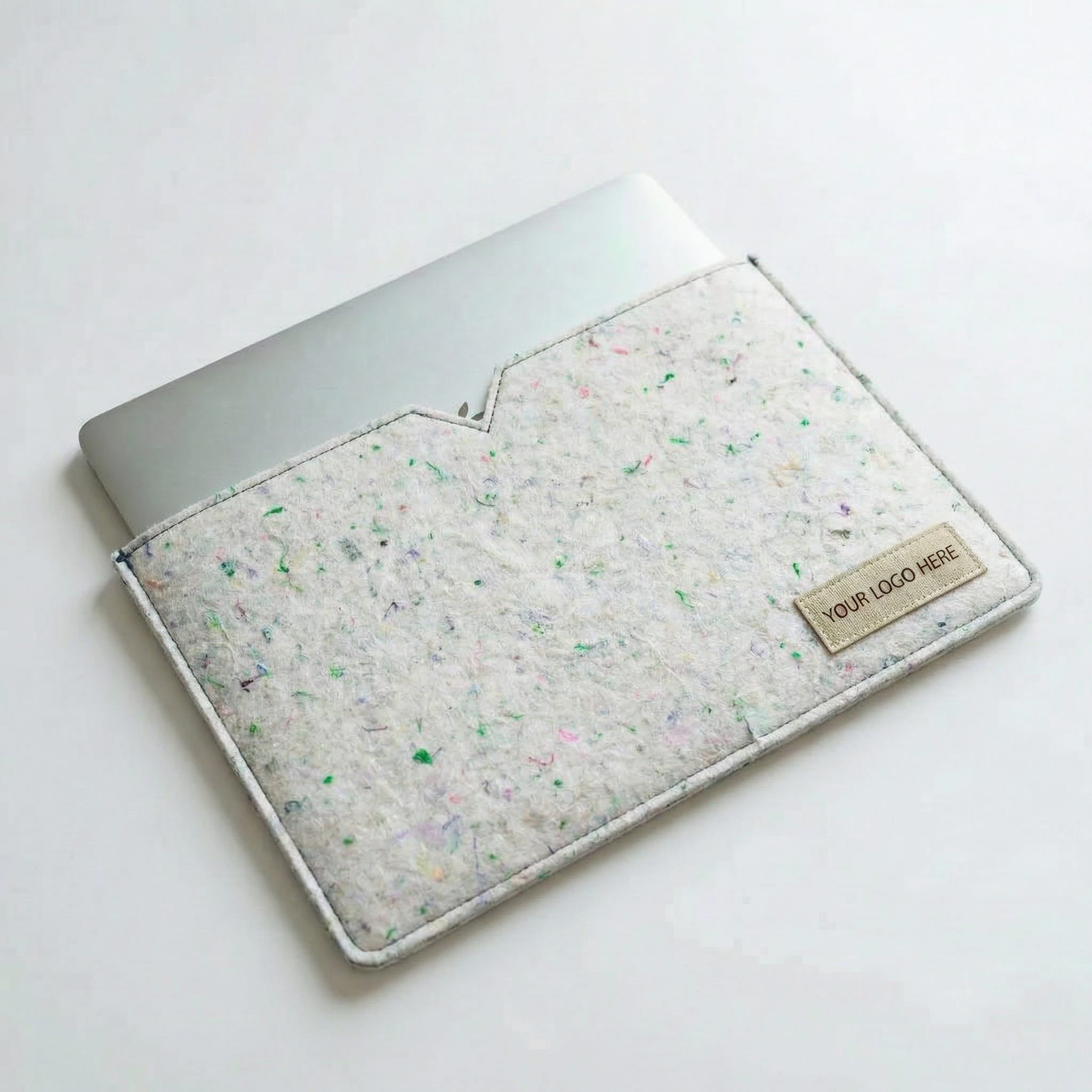 jaggery good felt laptop sleeve cream Cream colored laptop sleeve made from recycled textile waste with a laptop inside