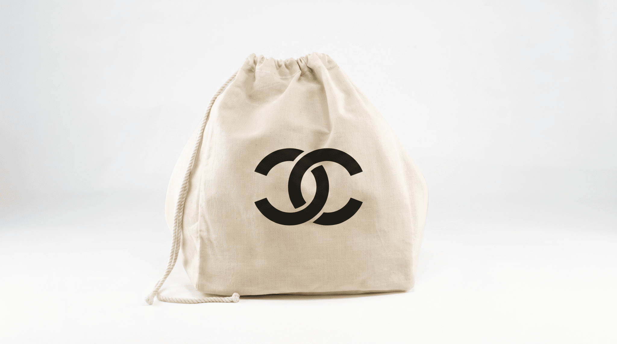mi eelo drawstring muslin gift bag fake logo A cream-colored drawstring muslin bag with a simple corporate logo sits against a white background