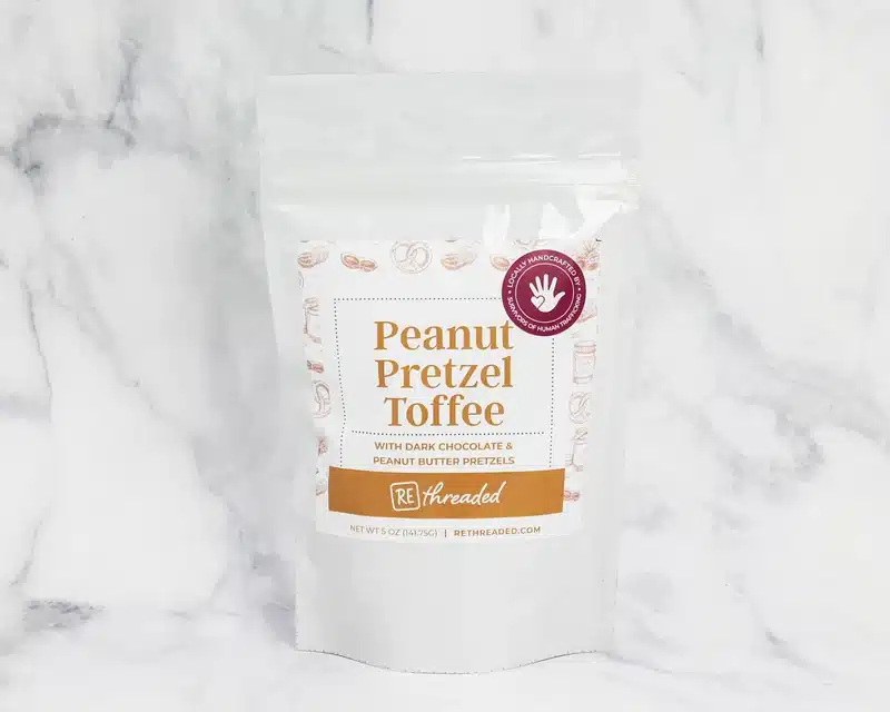5oz Peanut Pretzel Toffee Bag 800x A 5oz bag of peanut pretzel toffee made by women survivors